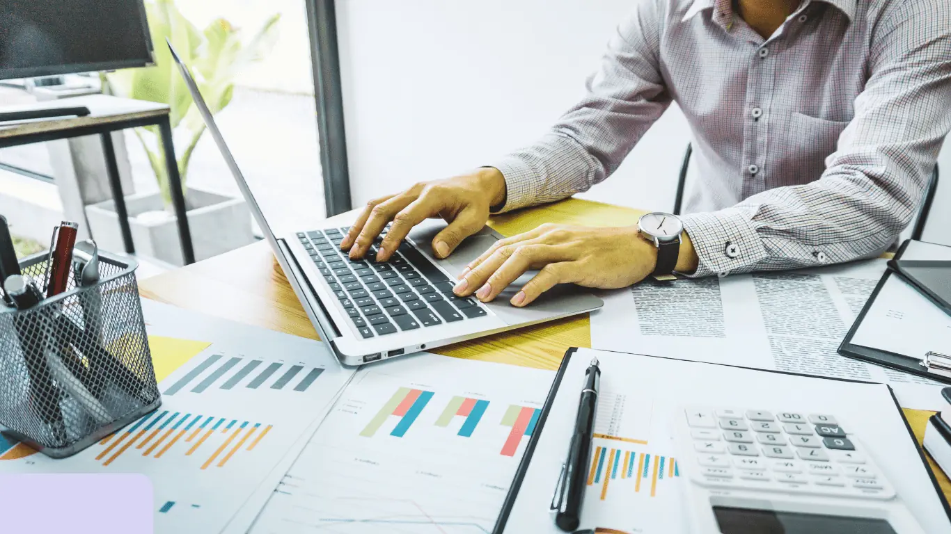 Person analyzing financial charts on laptop