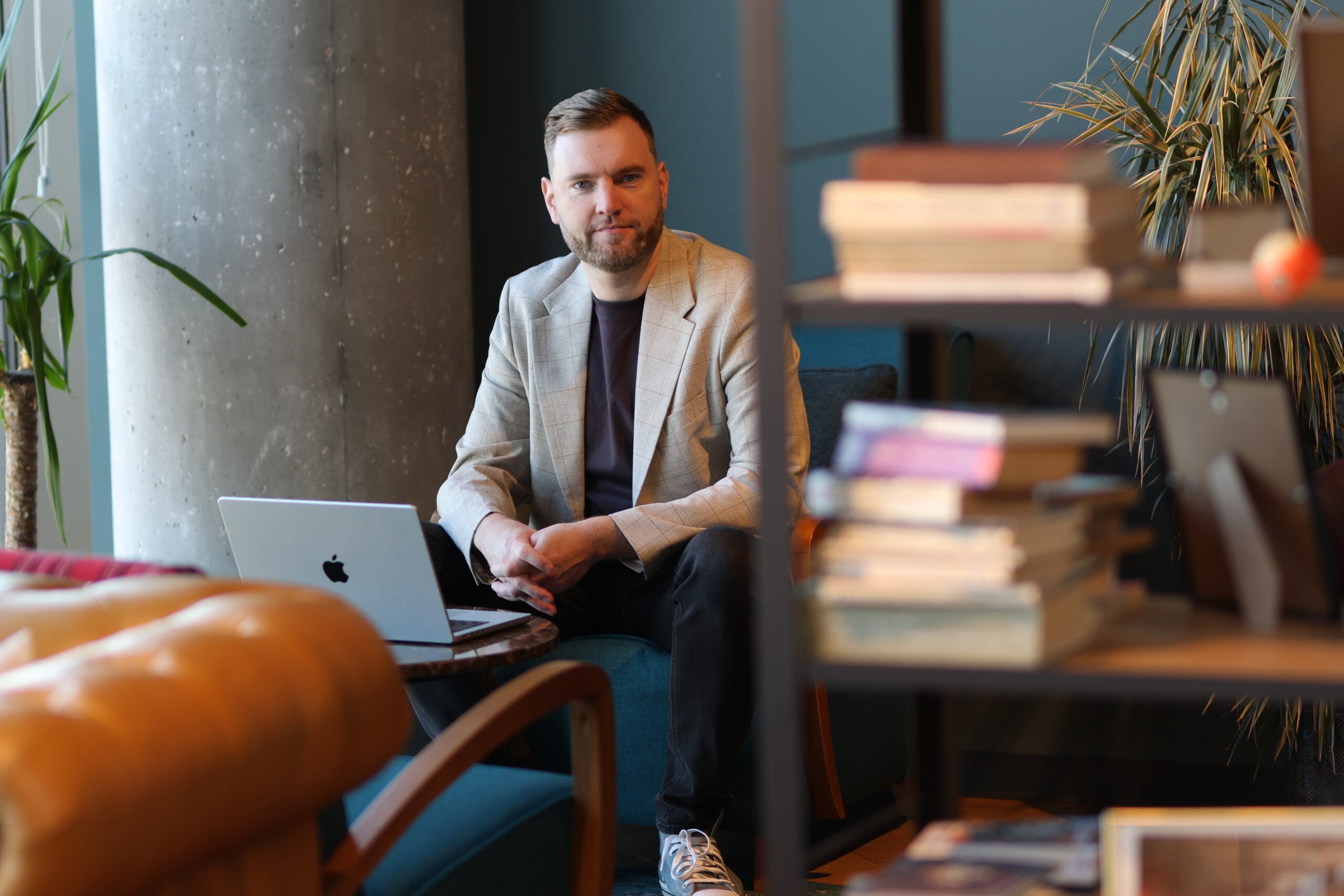 Man working on laptop in cozy office space.