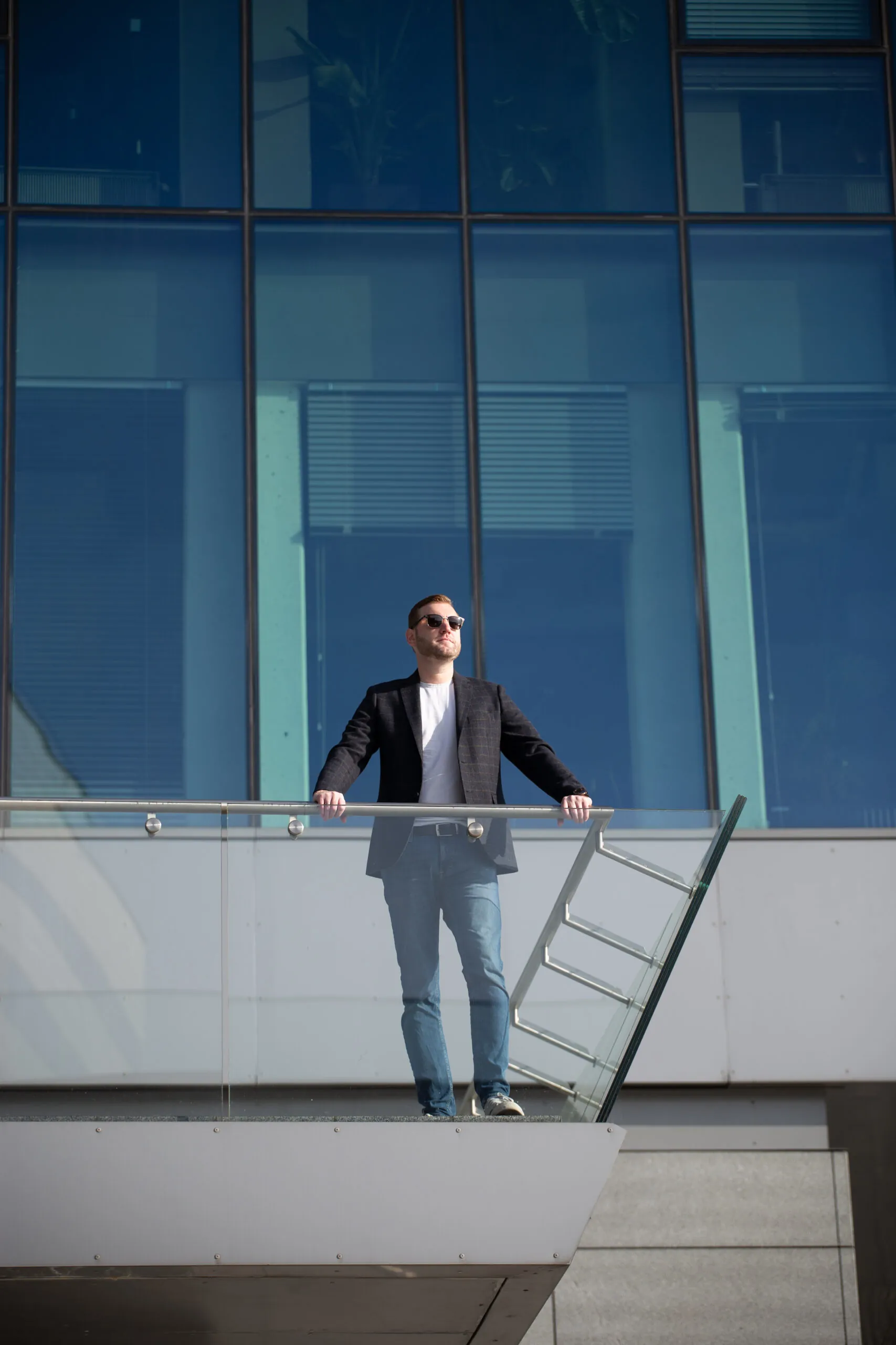 Man standing on modern building balcony